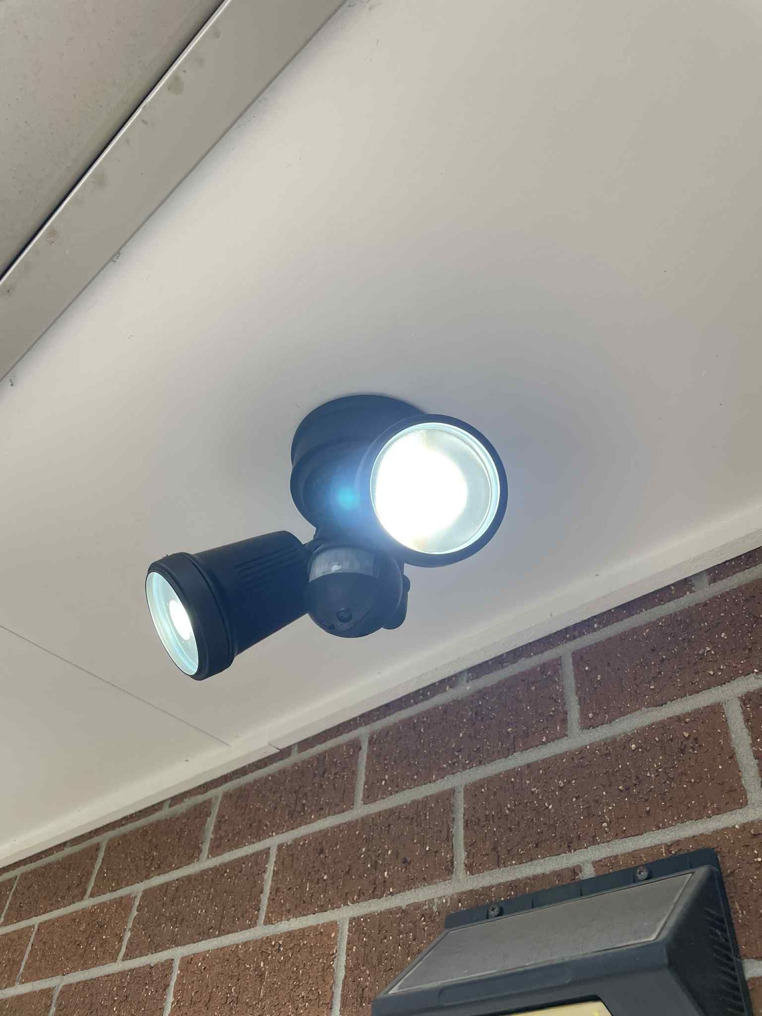 Electrician replacing faulty socket outlet in living room