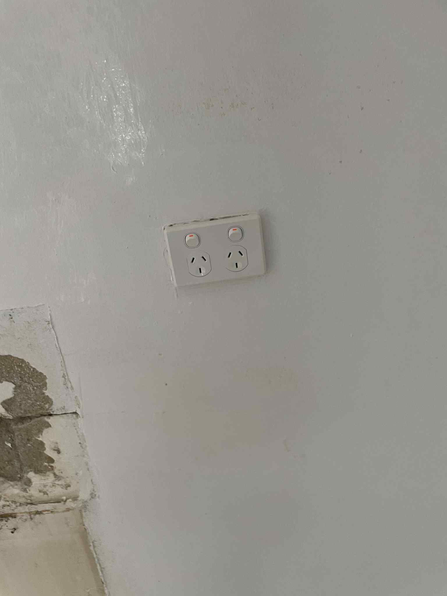 Electrician fitting weatherproof bathroom light switch