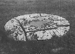 A black and white photo of a hole in the ground