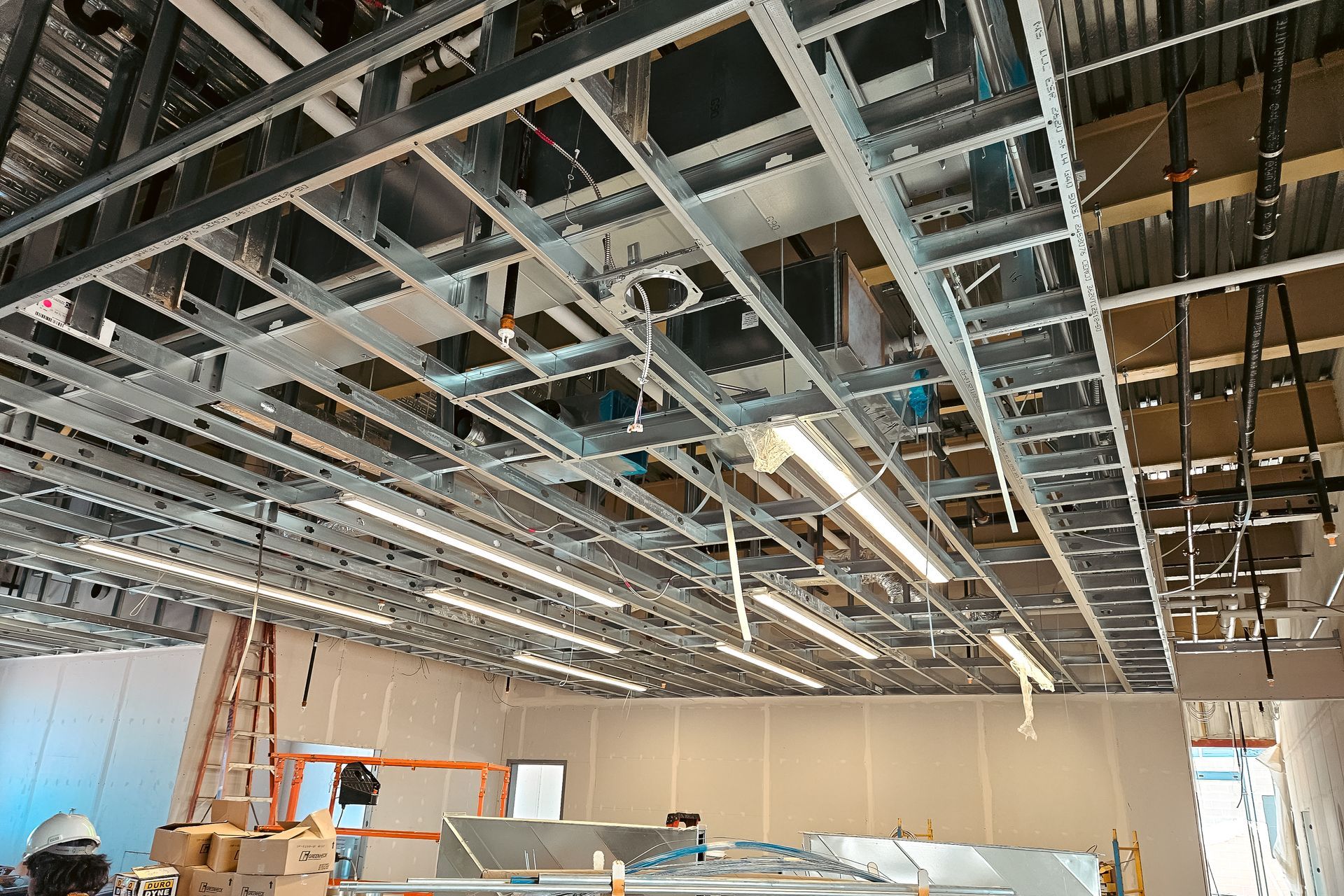 A large room with a ceiling that is being built