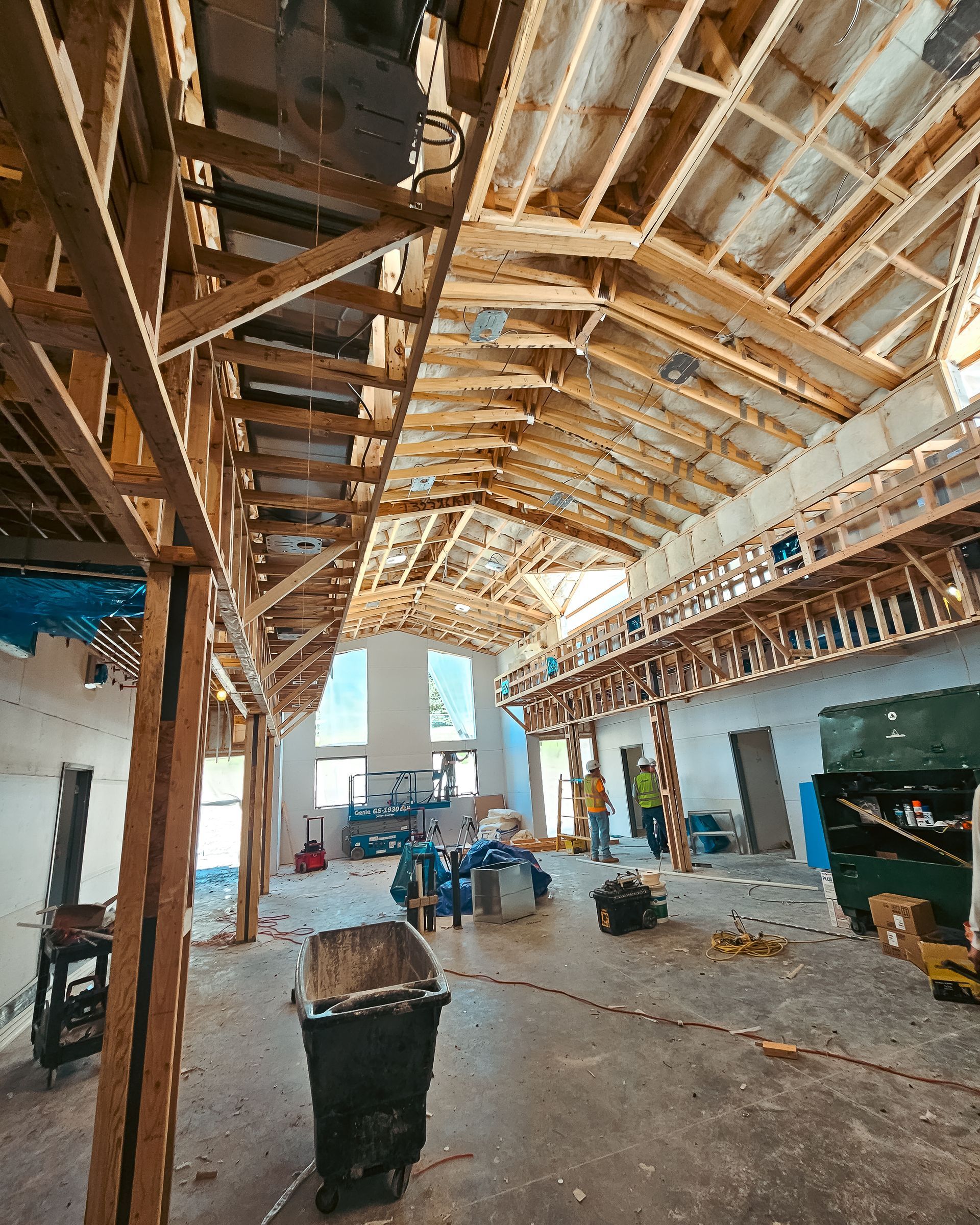 A large building under construction with a lot of wooden beams.