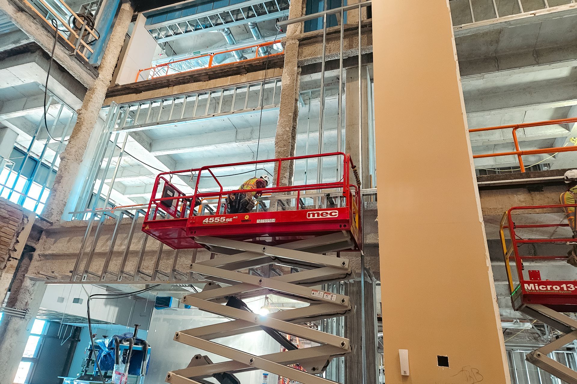 A group of construction workers are working on a large building.