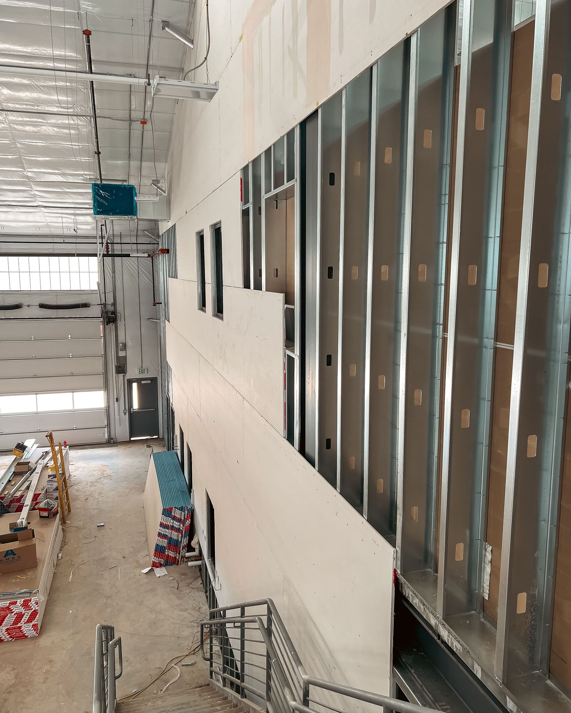 A building under construction with a blue sign on the ceiling