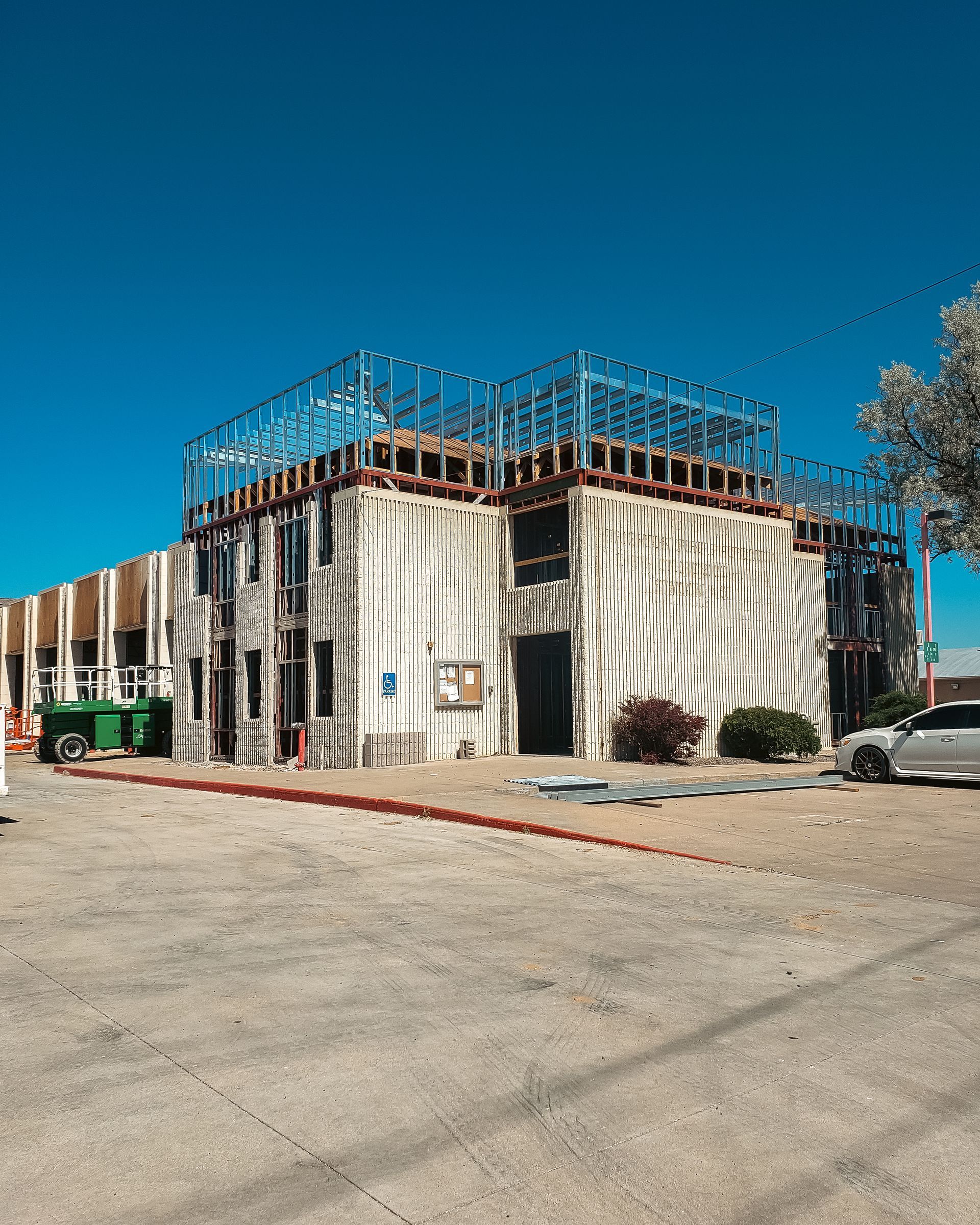 A large building under construction with a blue sky in the background.