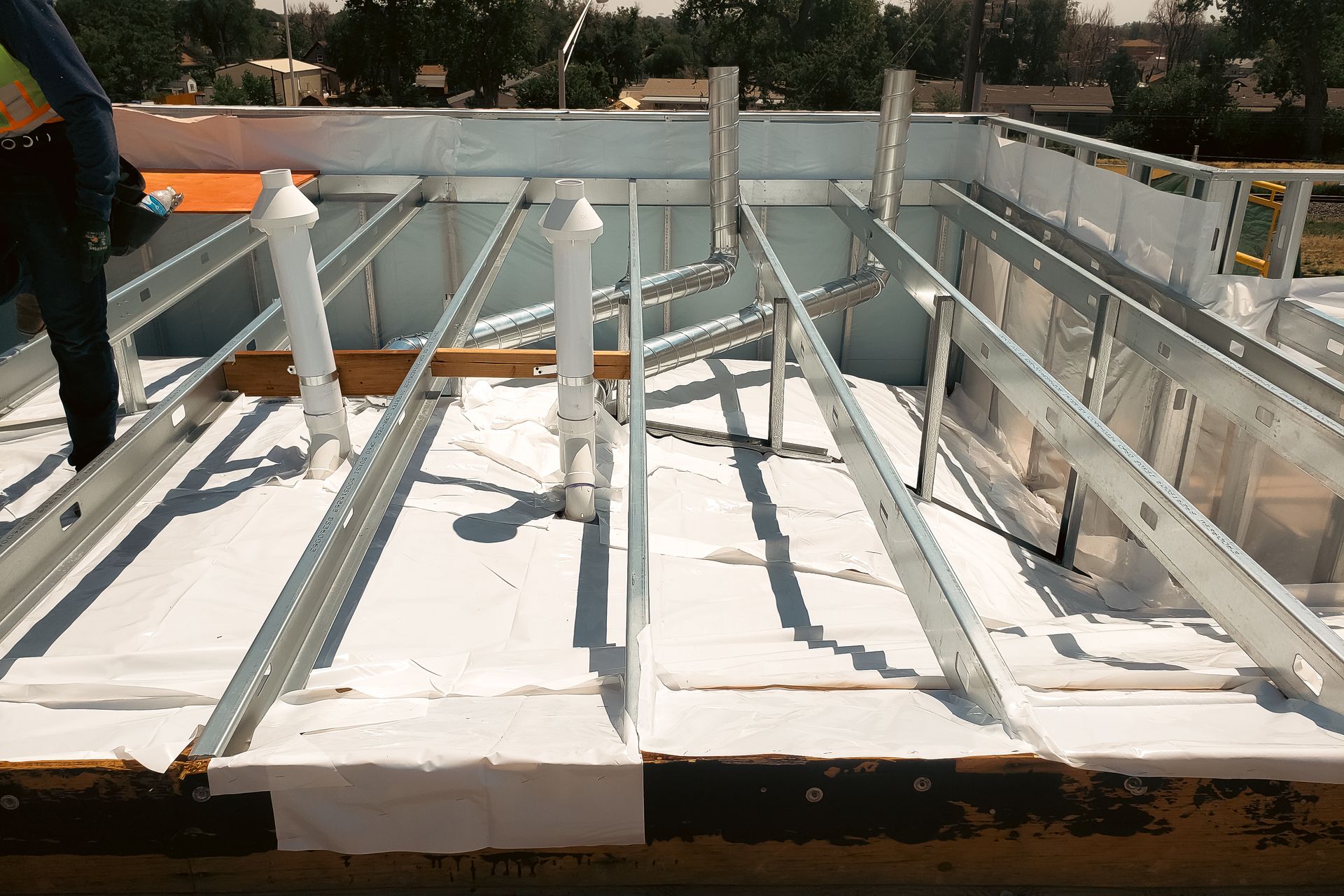 A man is working on the roof of a building