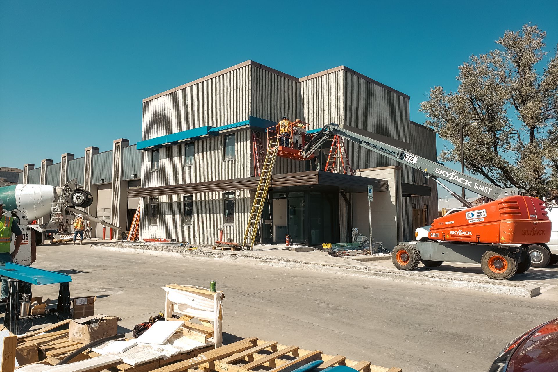 A construction site with a building under construction and a crane.