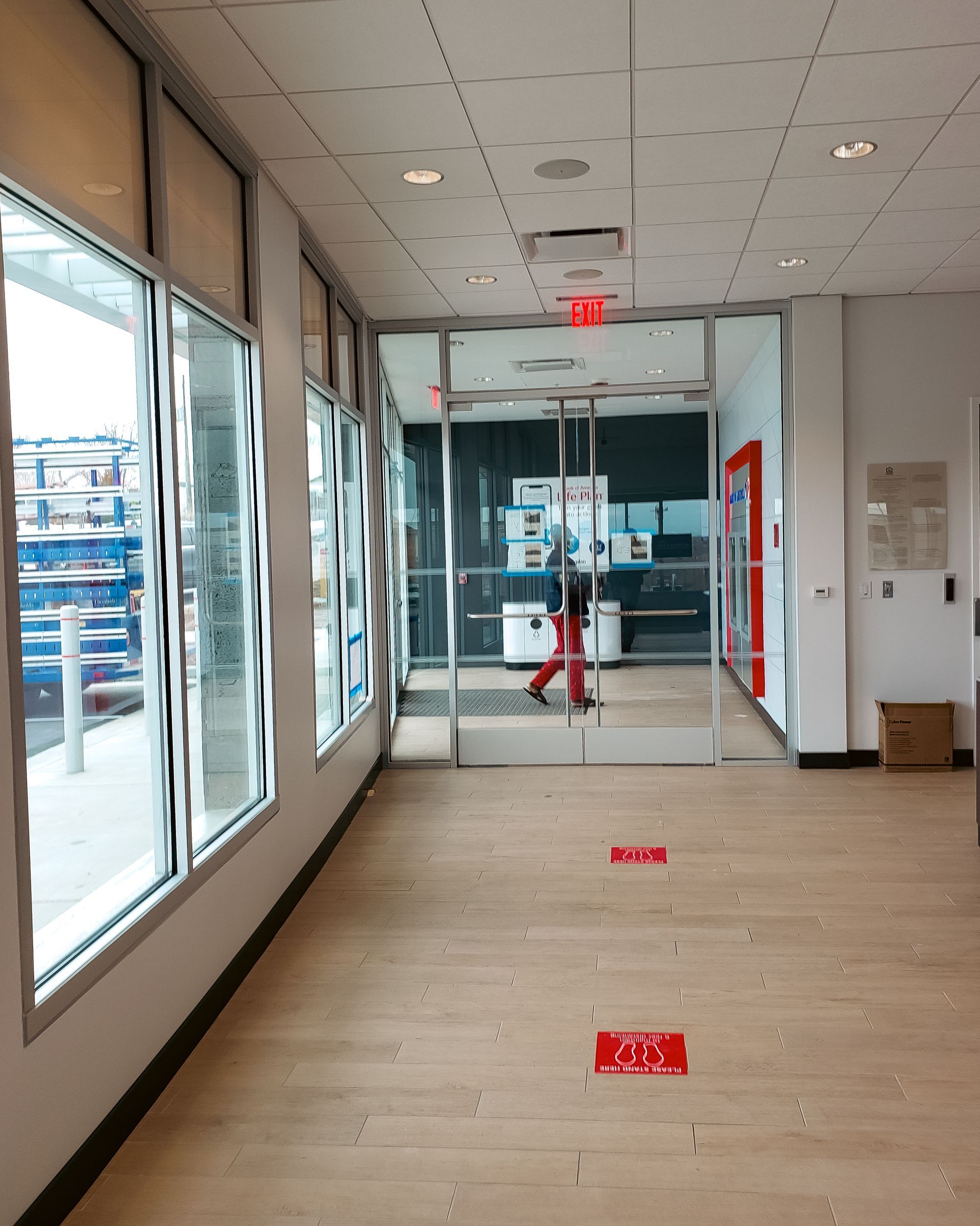 A hallway with a red exit sign on the floor
