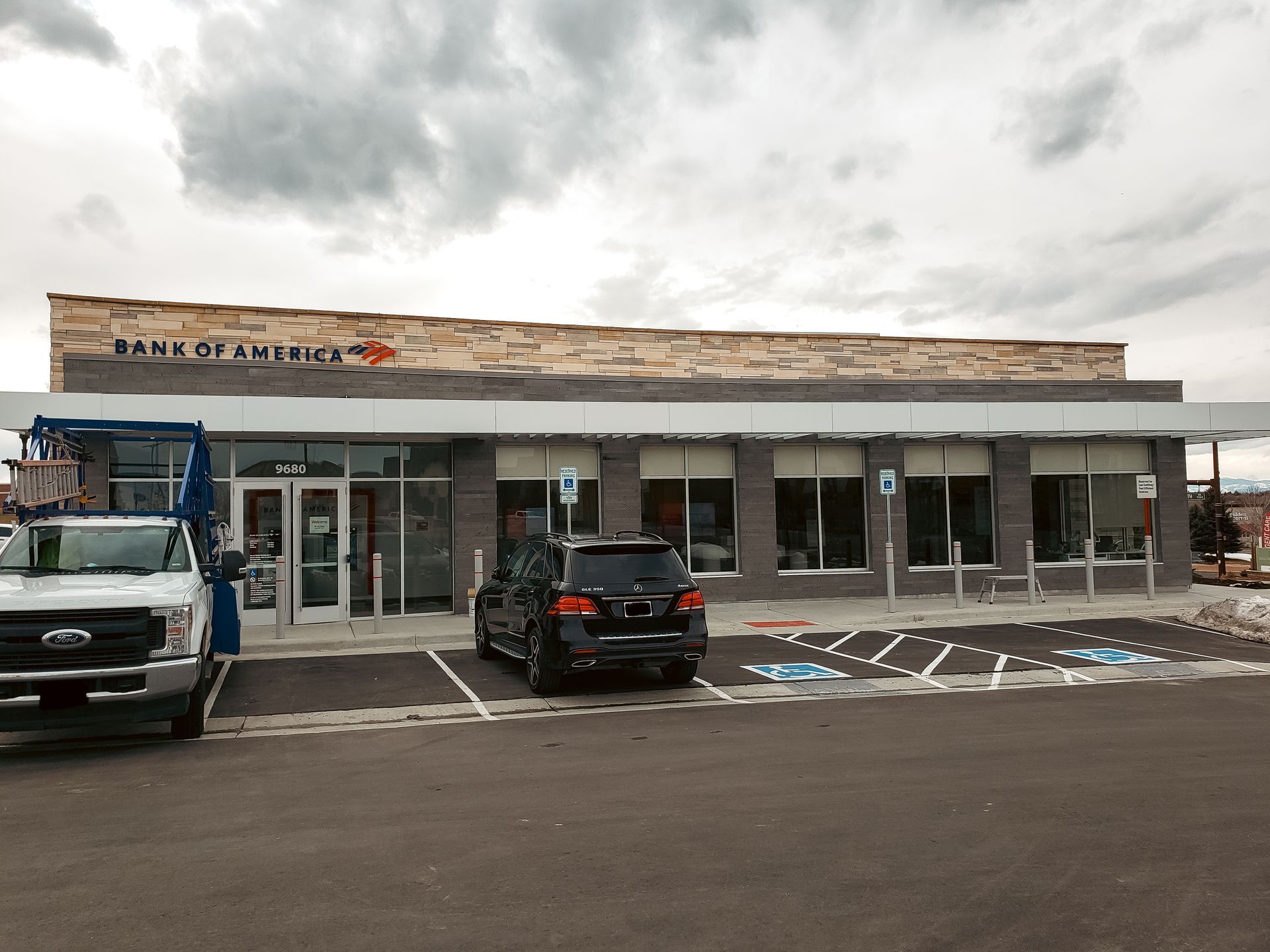 A bank of america building with cars parked in front of it