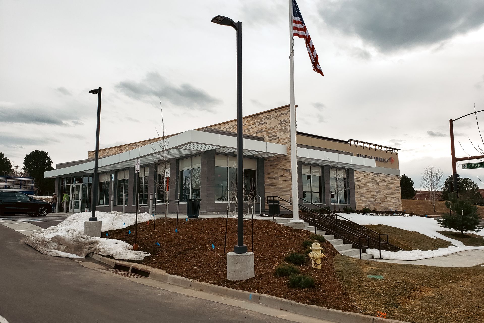An american flag is flying in front of a building