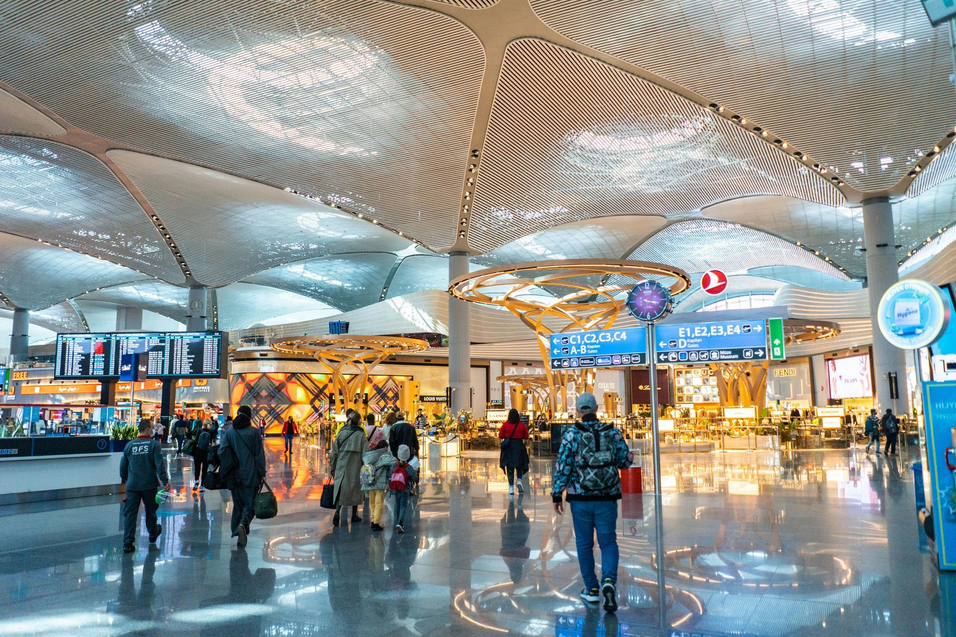 A group of people are walking through an airport terminal.