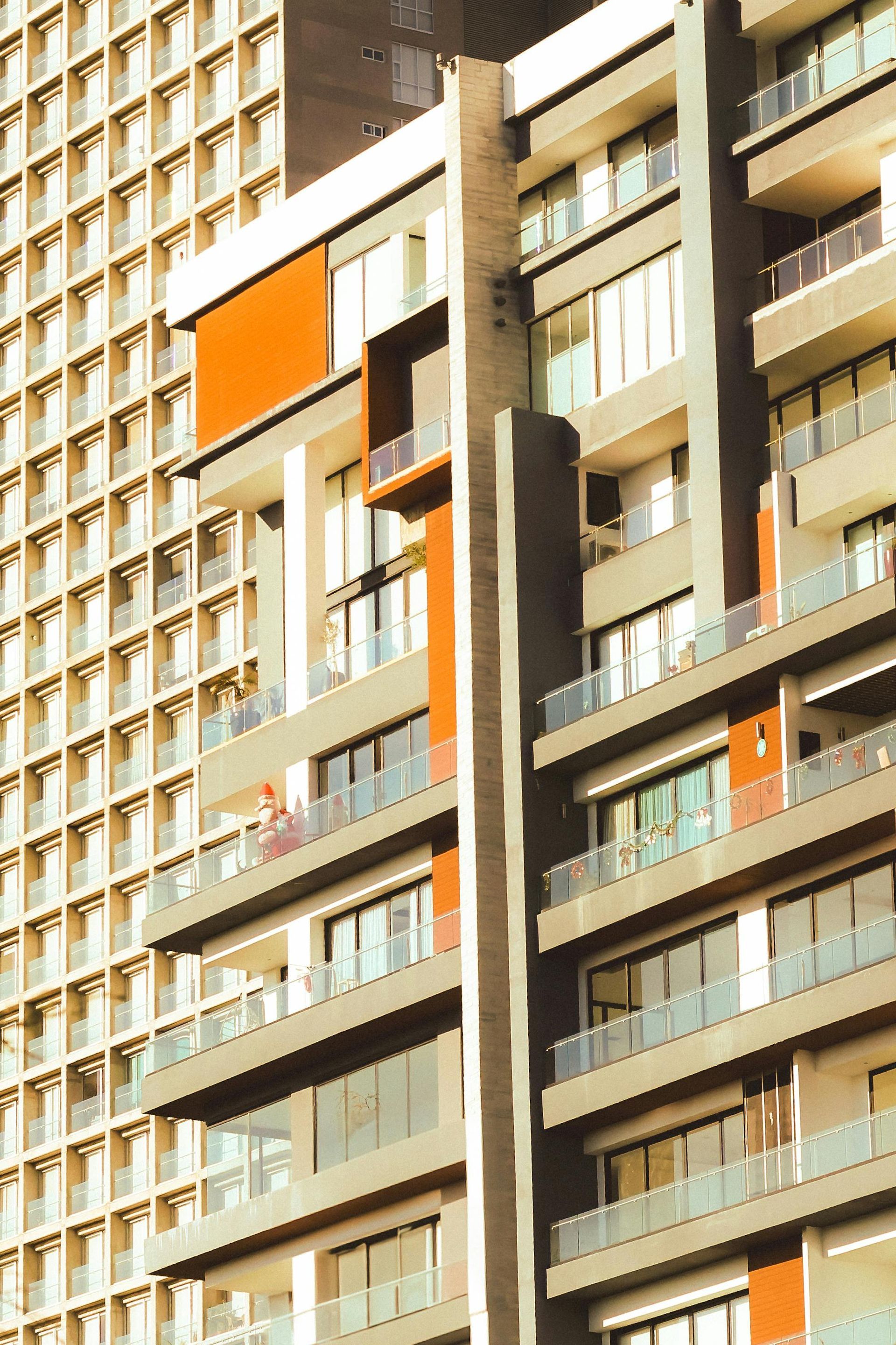 A tall building with a lot of windows and balconies