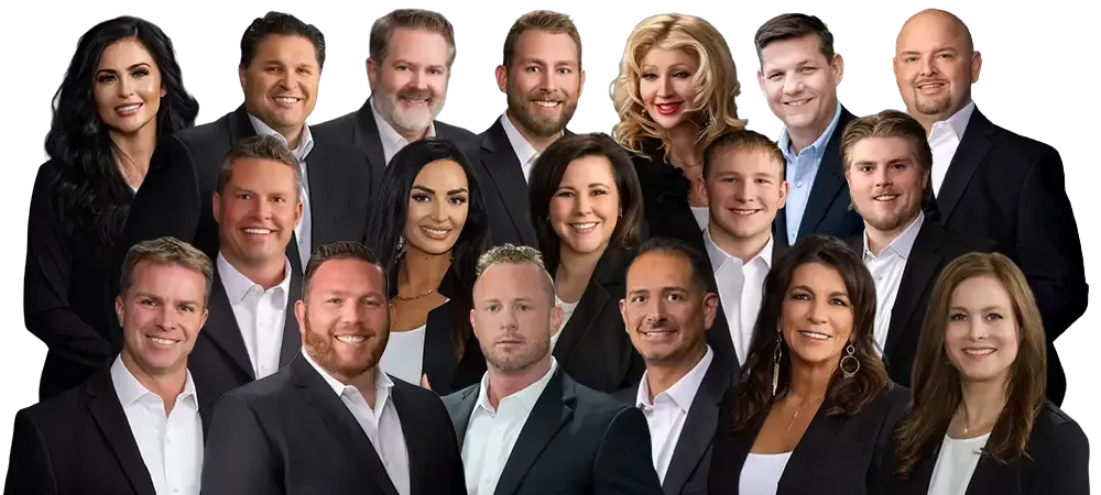 A group of people posing together, holding a picture of a building. They are smiling.