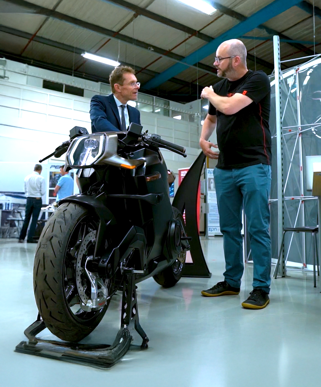 Andy Street talking to someone over a motorbike