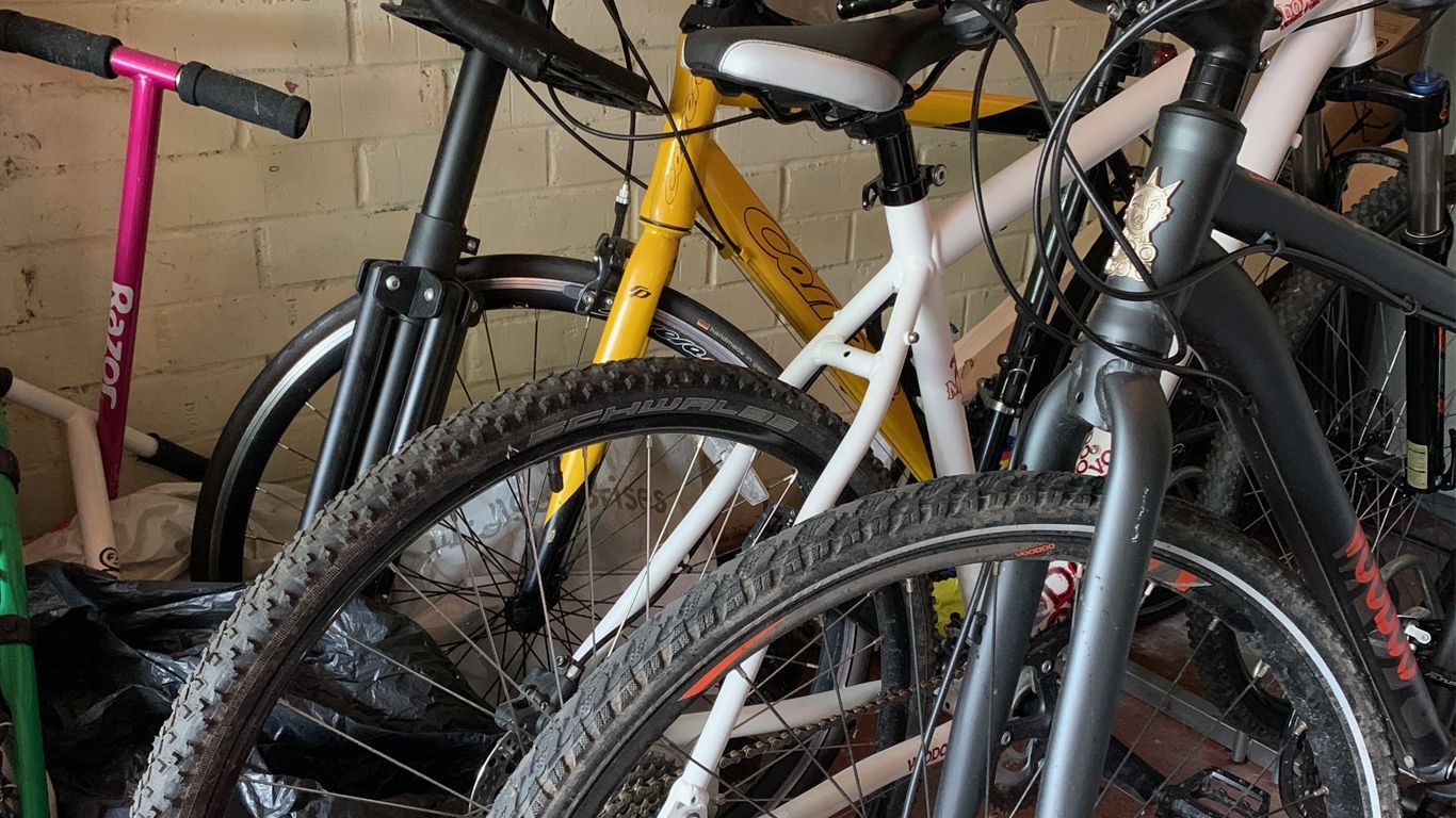 cluttered bikes in a garage
