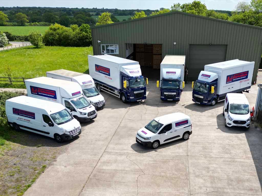A fleet of removal lorries parked in front of AJ Stephenson Removals premises in Billericay.