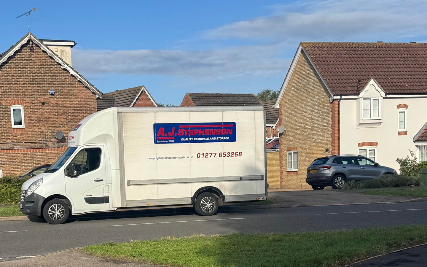 House removal van with AJ Stephenson Removals logo; blue sky above.