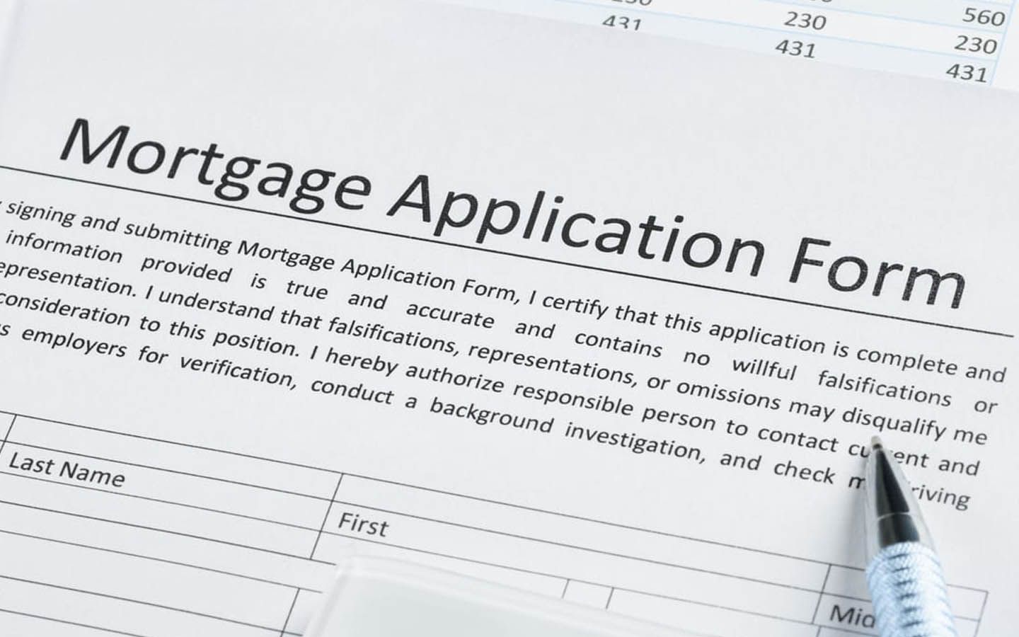 A pen is sitting on top of a mortgage application form
