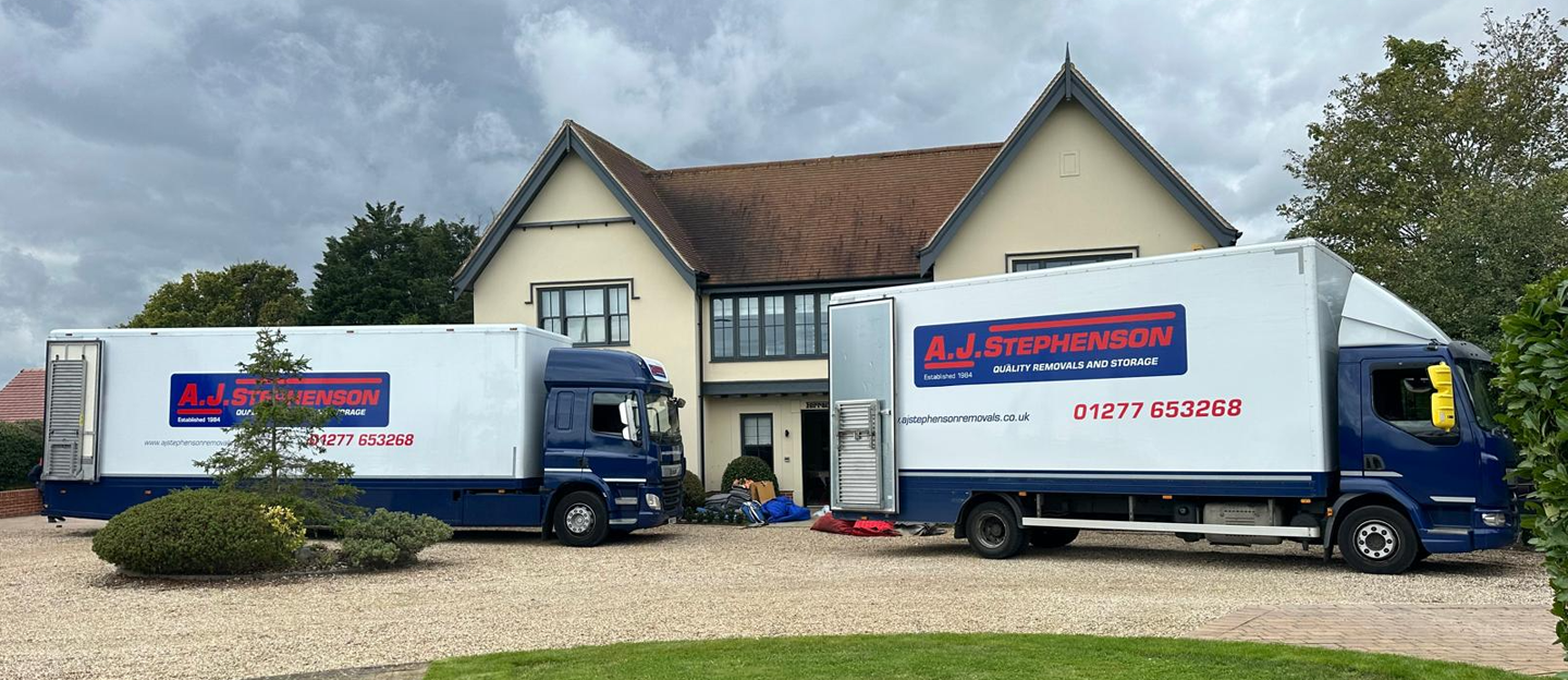 AJ Stephenson Removals lorries moving a house