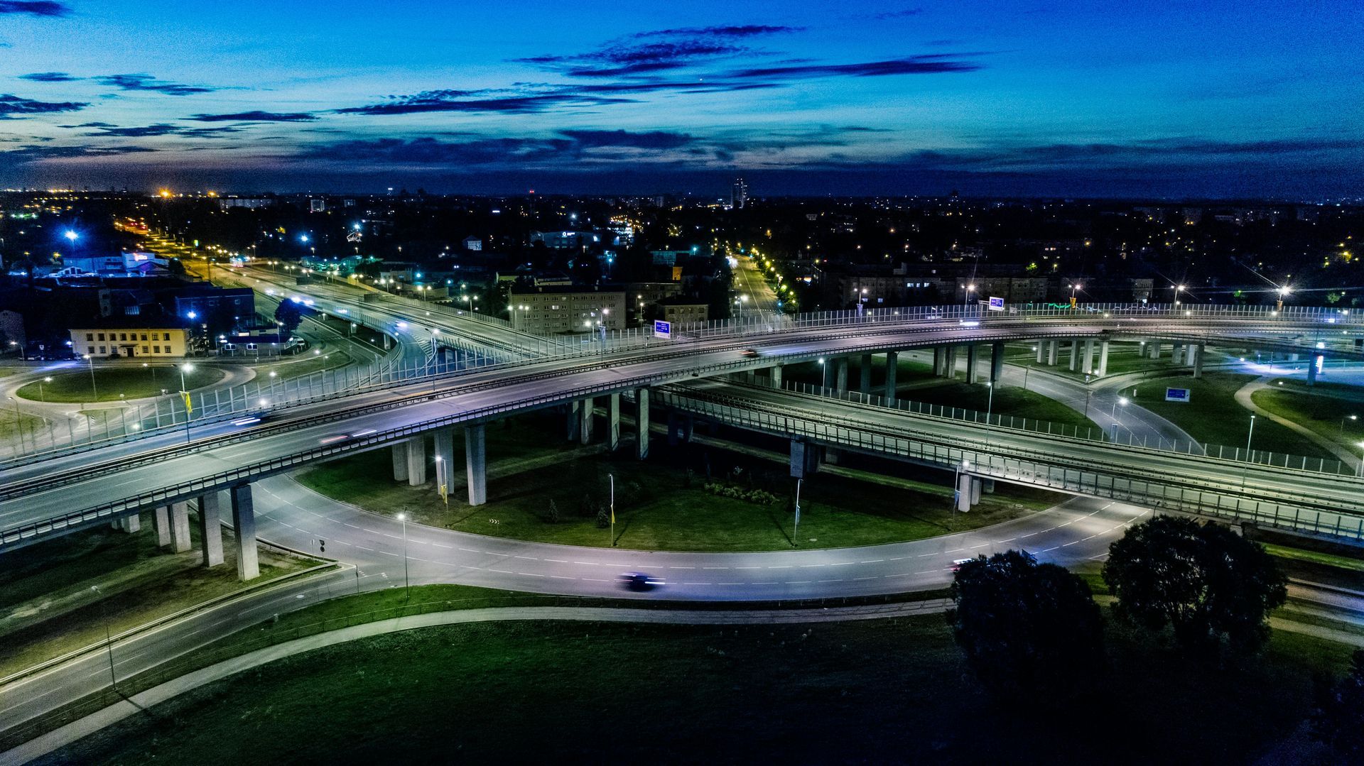 An aerial view of a bridge over a river at night.