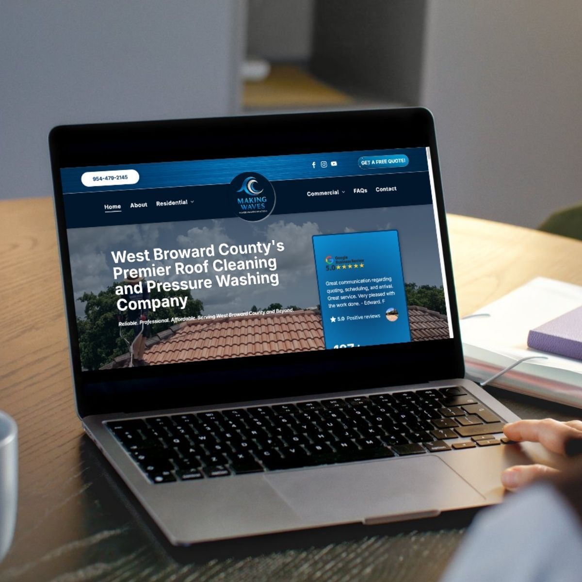 Laptop displaying a website for a roof cleaning company, featuring their logo and services