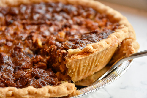 a pecan pie with a slice taken out of it