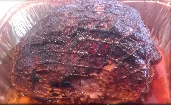 a large piece of meat is sitting in a plastic container