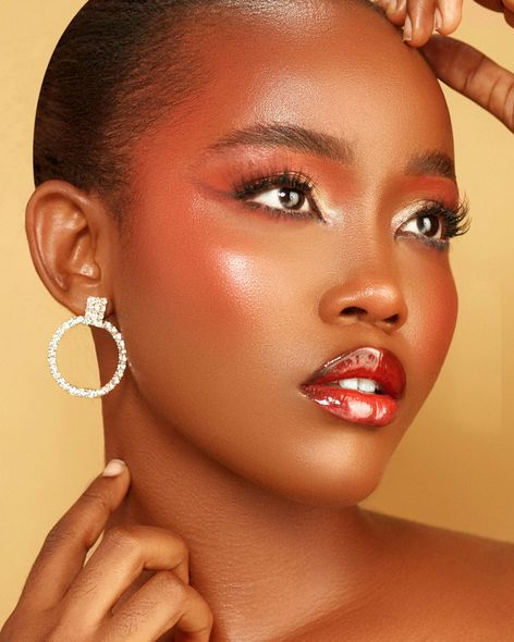 A close up of a woman 's face with red lipstick and earrings