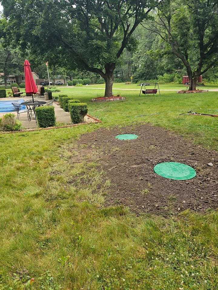 A lush green lawn with a swimming pool in the background.