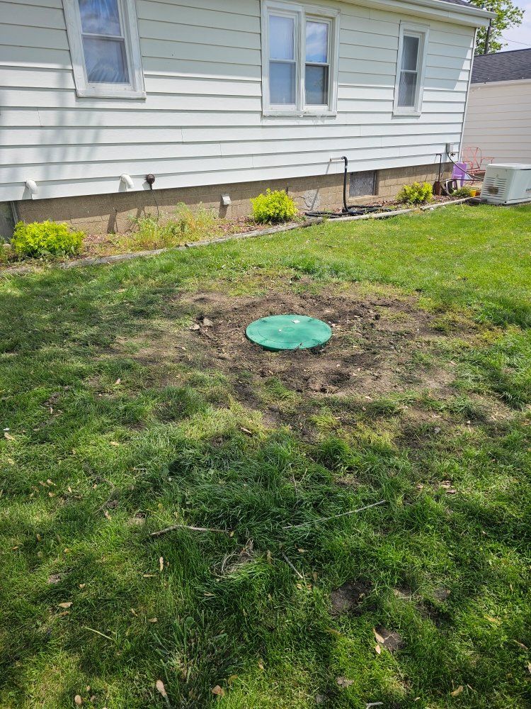 A house with a septic tank in the backyard.