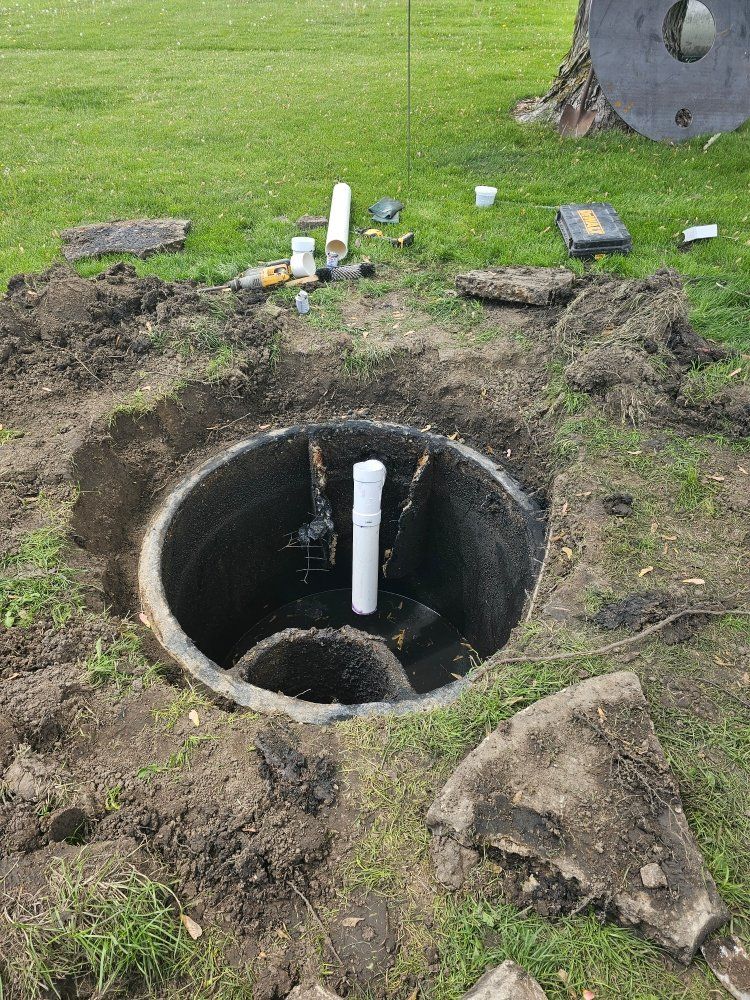 A large hole in the ground with a pipe in it.