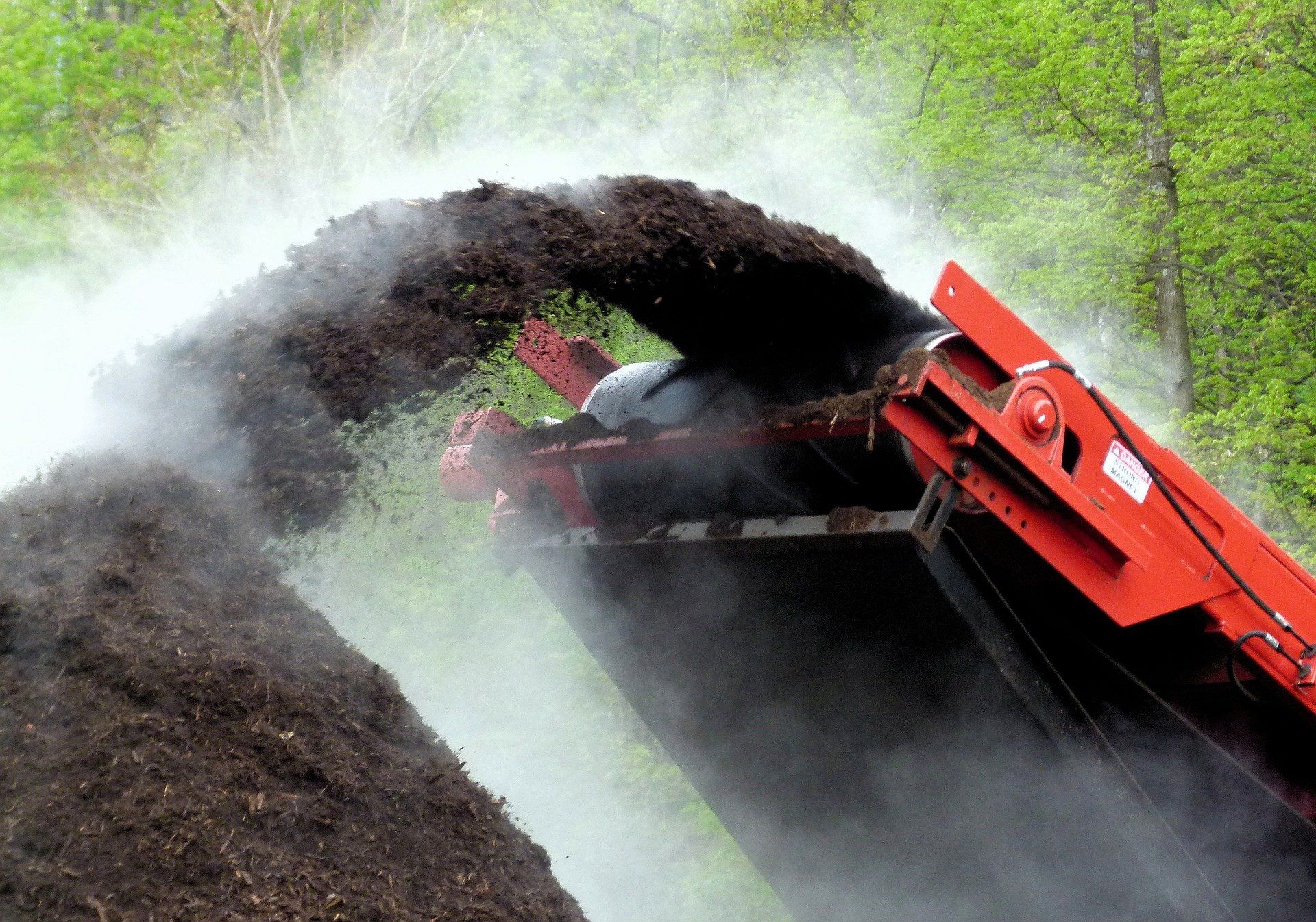 Compost grinder in action, turning organic waste into nutrient-rich soil amendment.