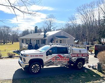 a white truck is parked in front of a house .