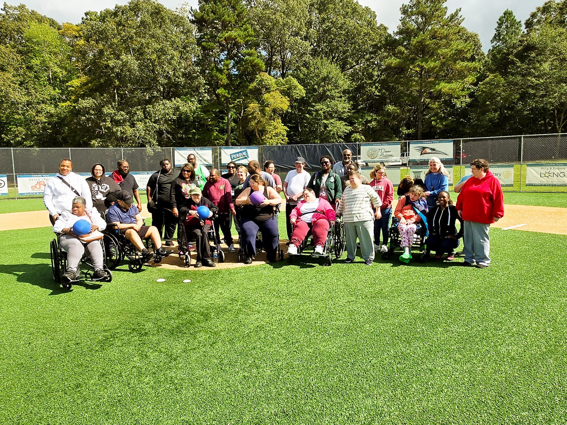 Clients & Staff playing a game of kickball on a beautiful day!