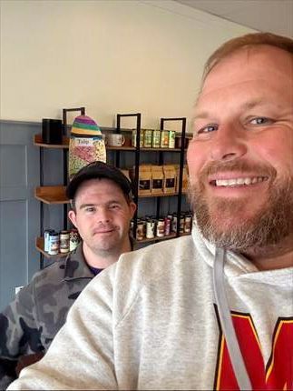 Rhett S. & mentor, Kyle M. meeting at cozy coffee shop. (2026)