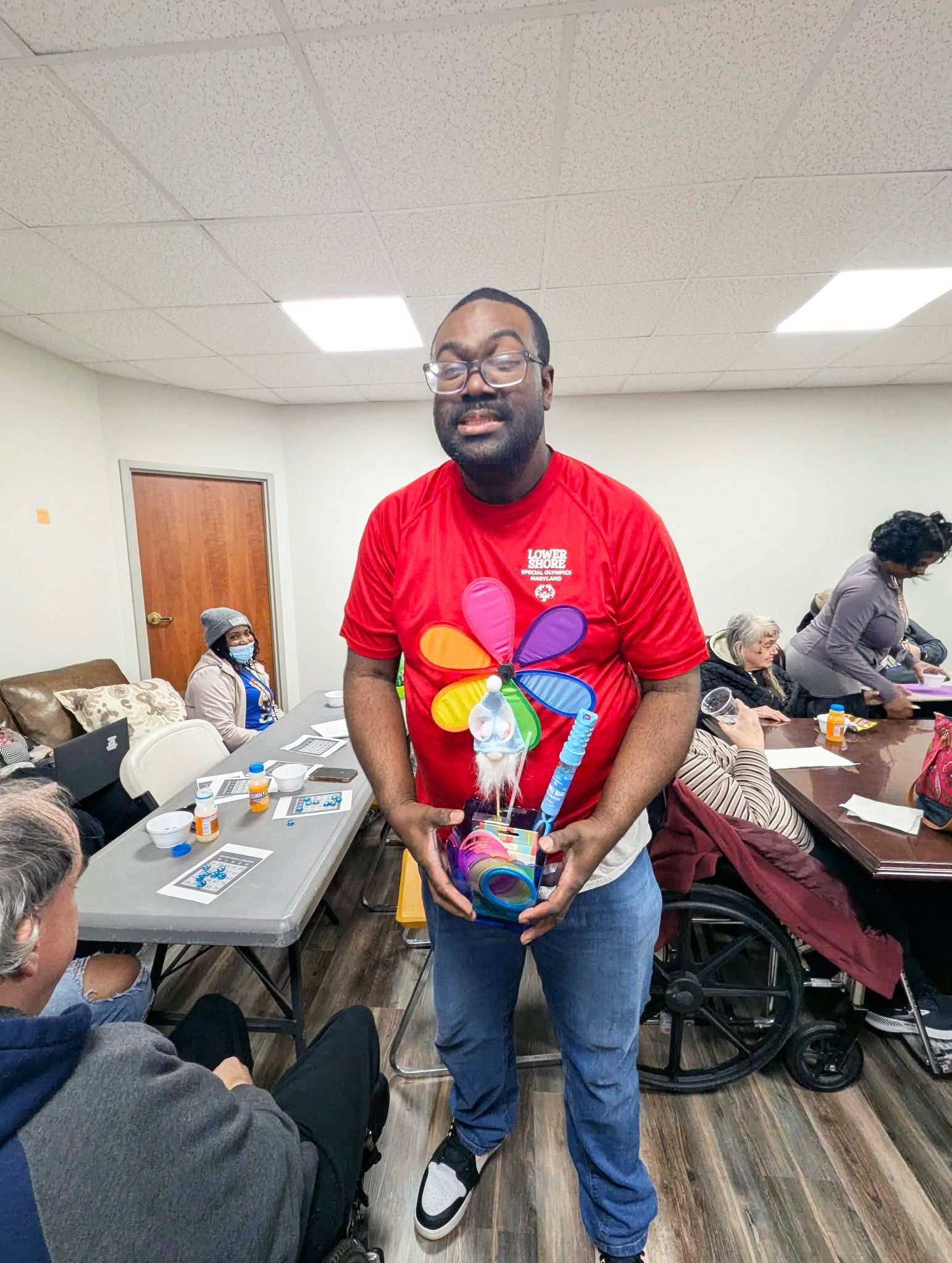 Lionel holding his prize after winning BINGO.