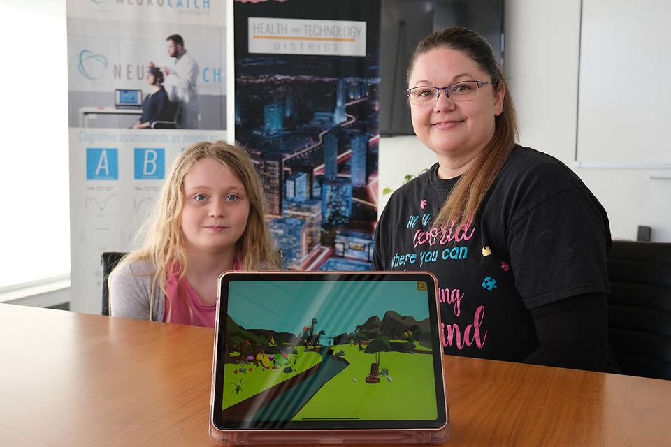 Jennifer Cox, right, a Langley resident who teaches in Surrey, and her 12-year-old daughter Addison, left, are part of the “Dino Island” intervention program therapeutic video game study. (submitted photo)