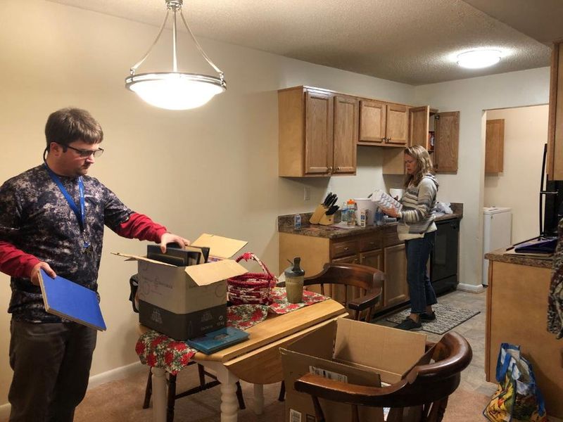 Drew Belote unpacks items in his apartment on Dec. 18. His mother, Pam, is in the background helping move Drew into his first home. (Courtesy / HANDOUT)