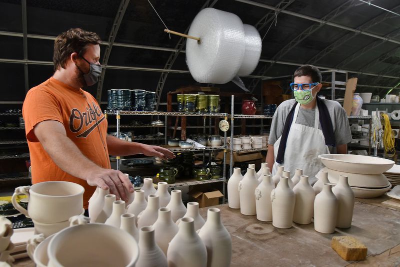 Tom Wright, left, a sales manager at Provident Center, talks with Eddie Harris, 36, who works at the pottery studio at Provident Center, where participants make pottery for sale. The Provident Center helps individuals with disabilities to build independent lived in their community. (Amy Davis / Baltimore Sun)