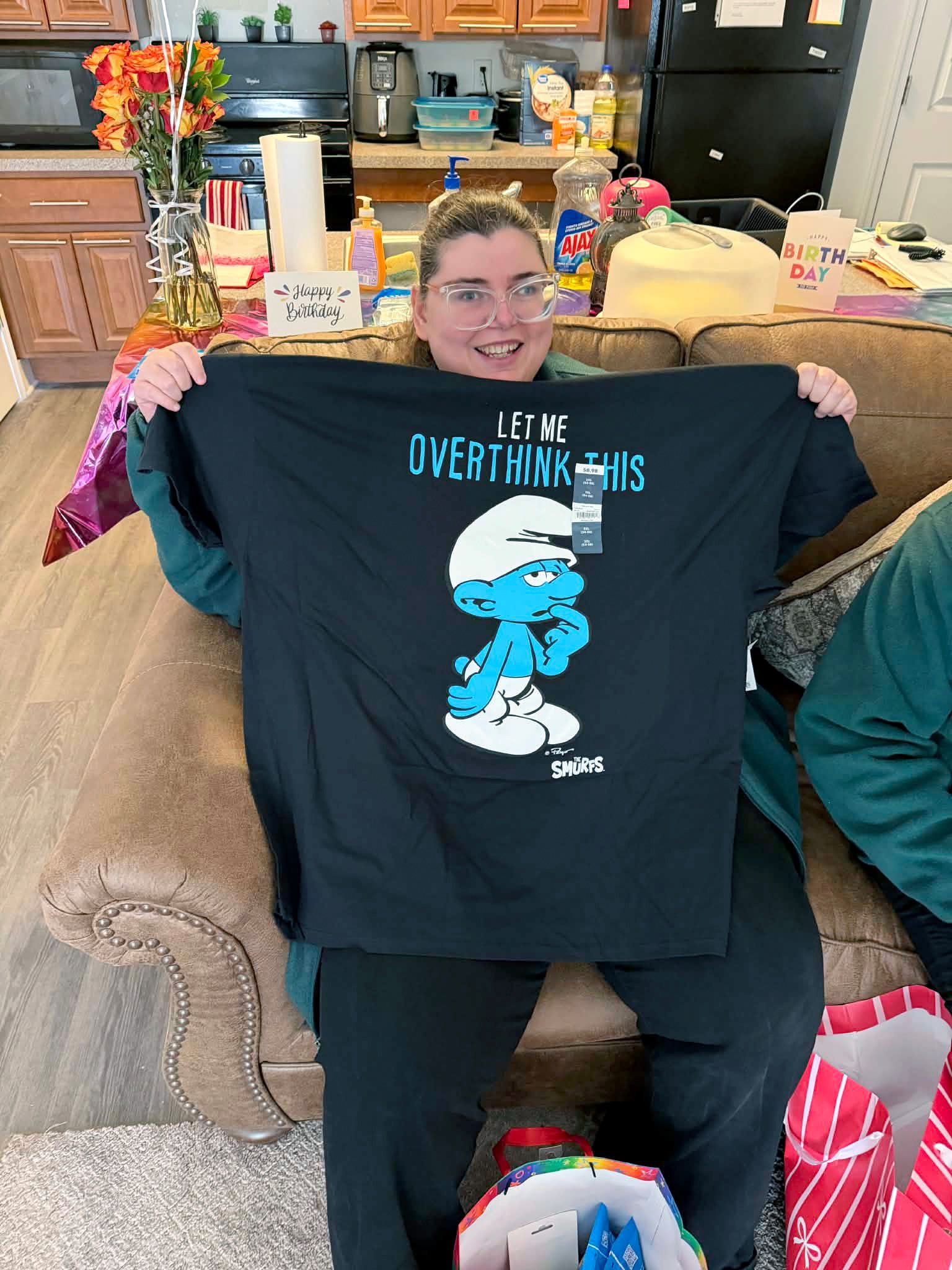 Tiffany holding up her new Smurfs t-shirt.