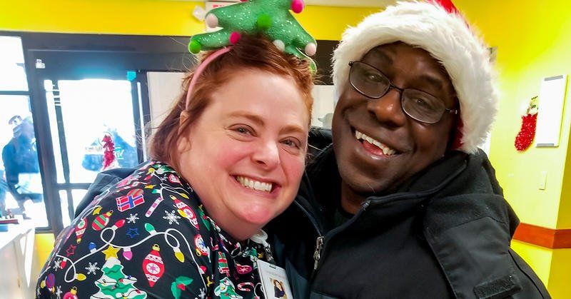 Chrissy Perkins and Demetrius Broyles pose at a Christmas party pre-pandemic. At one holiday party, he got the chance to pie her in the face.