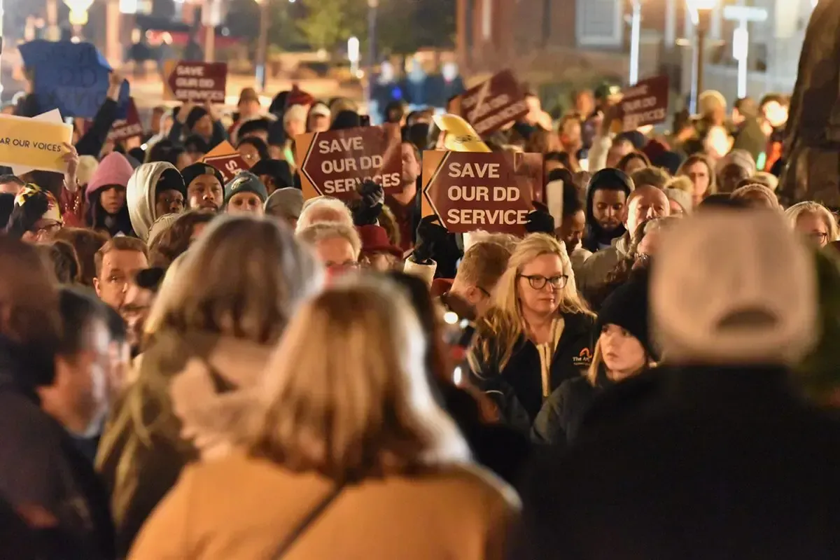 Advocates for people with developmental disabilities rallied at the State House Monday night in oppo