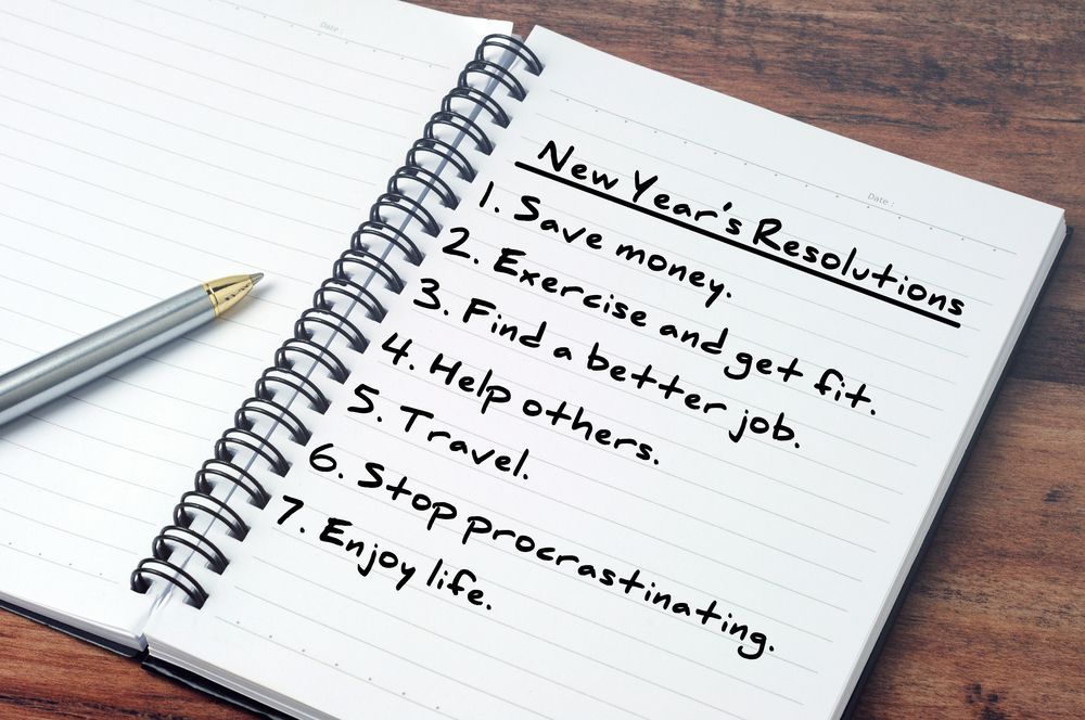 A notebook with new year 's resolutions written on it