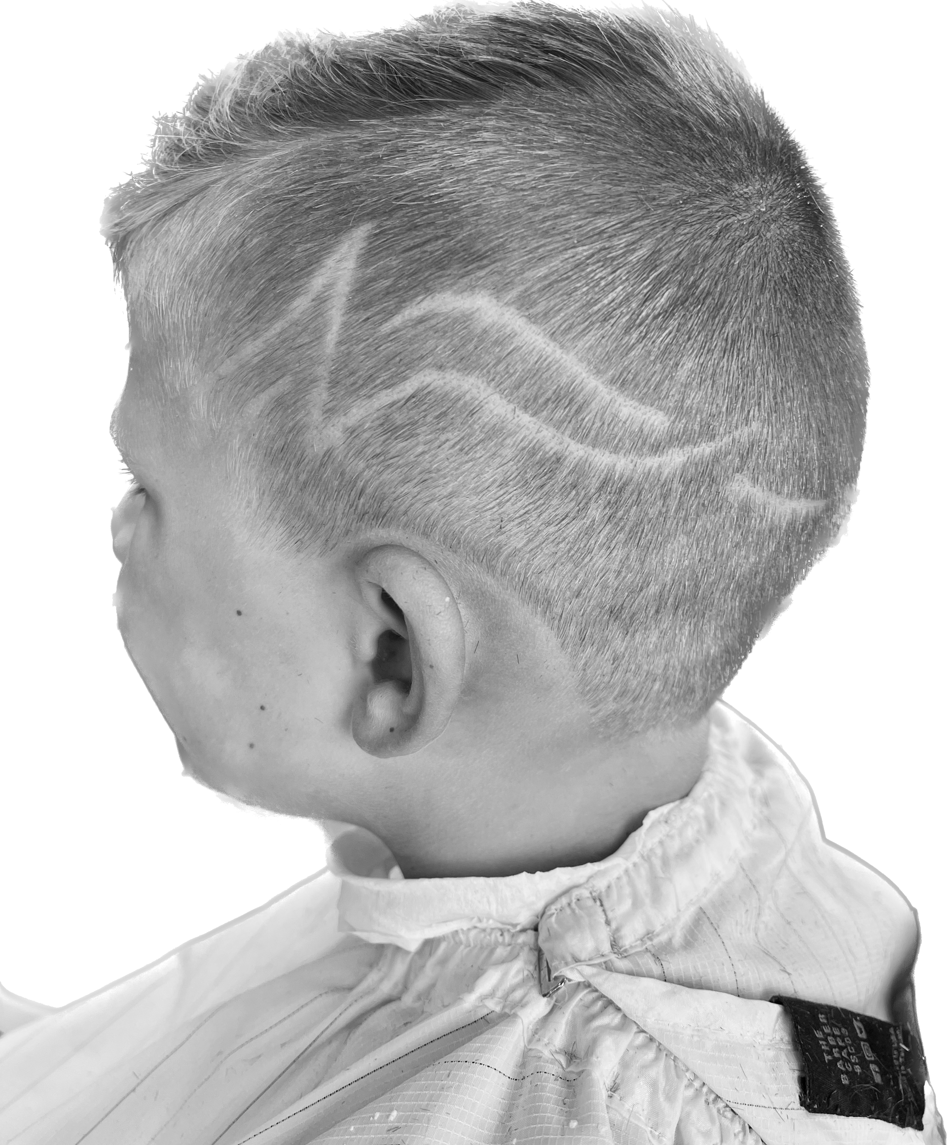 Boy with short hair and a design shaved into the side of his head.