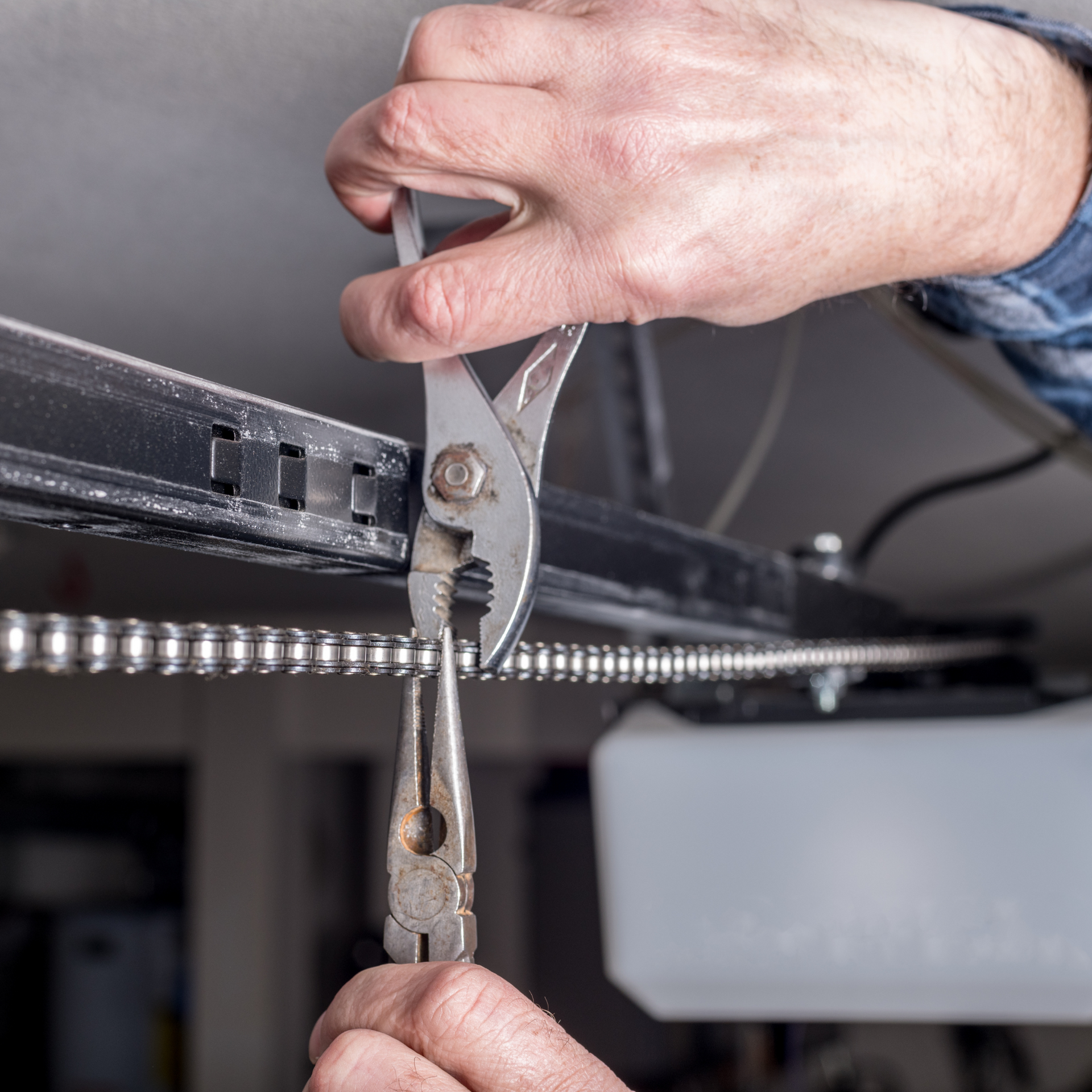 Garage door opener repair and chain adjustment for smooth automatic operation