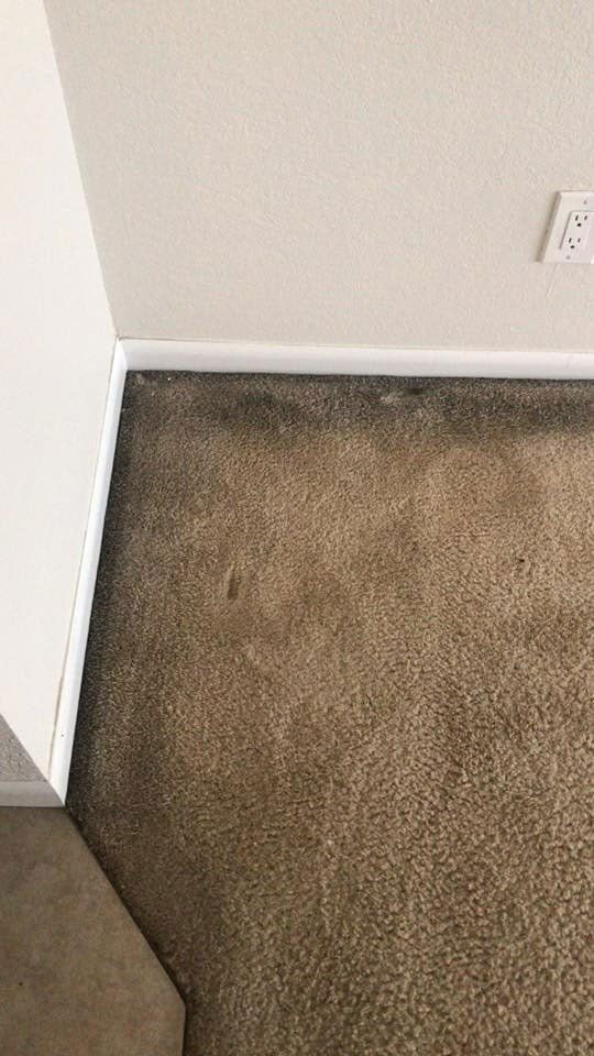 A close up of a brown carpet in a room.