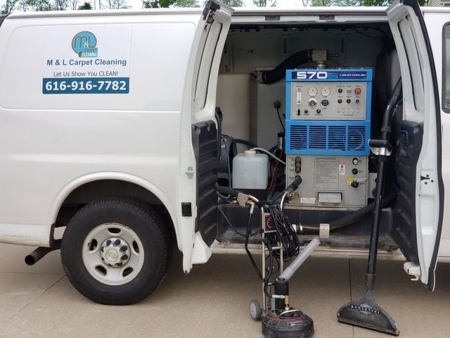 A white van with a vacuum cleaner inside of it