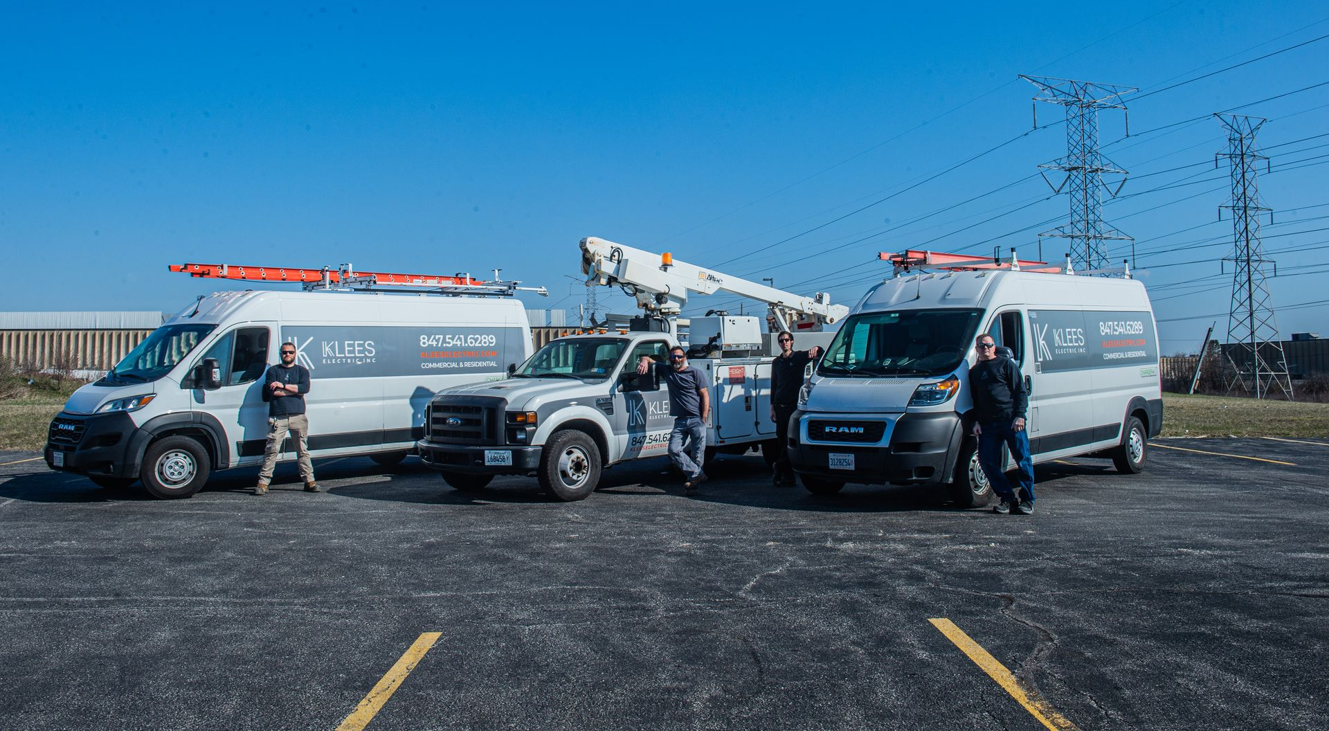A white utility truck is parked in a parking lot in front of a building.