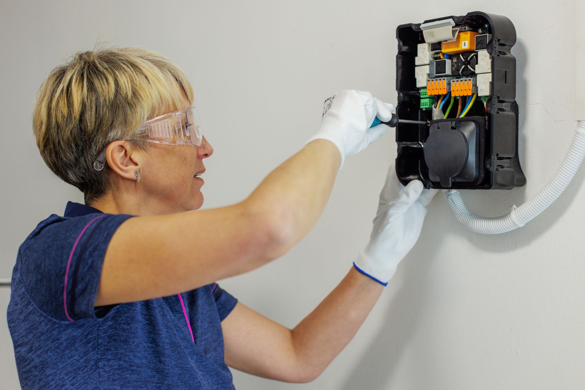 Electrician installing a subpanel for a home EV charger in Buffalo Grove, IL.