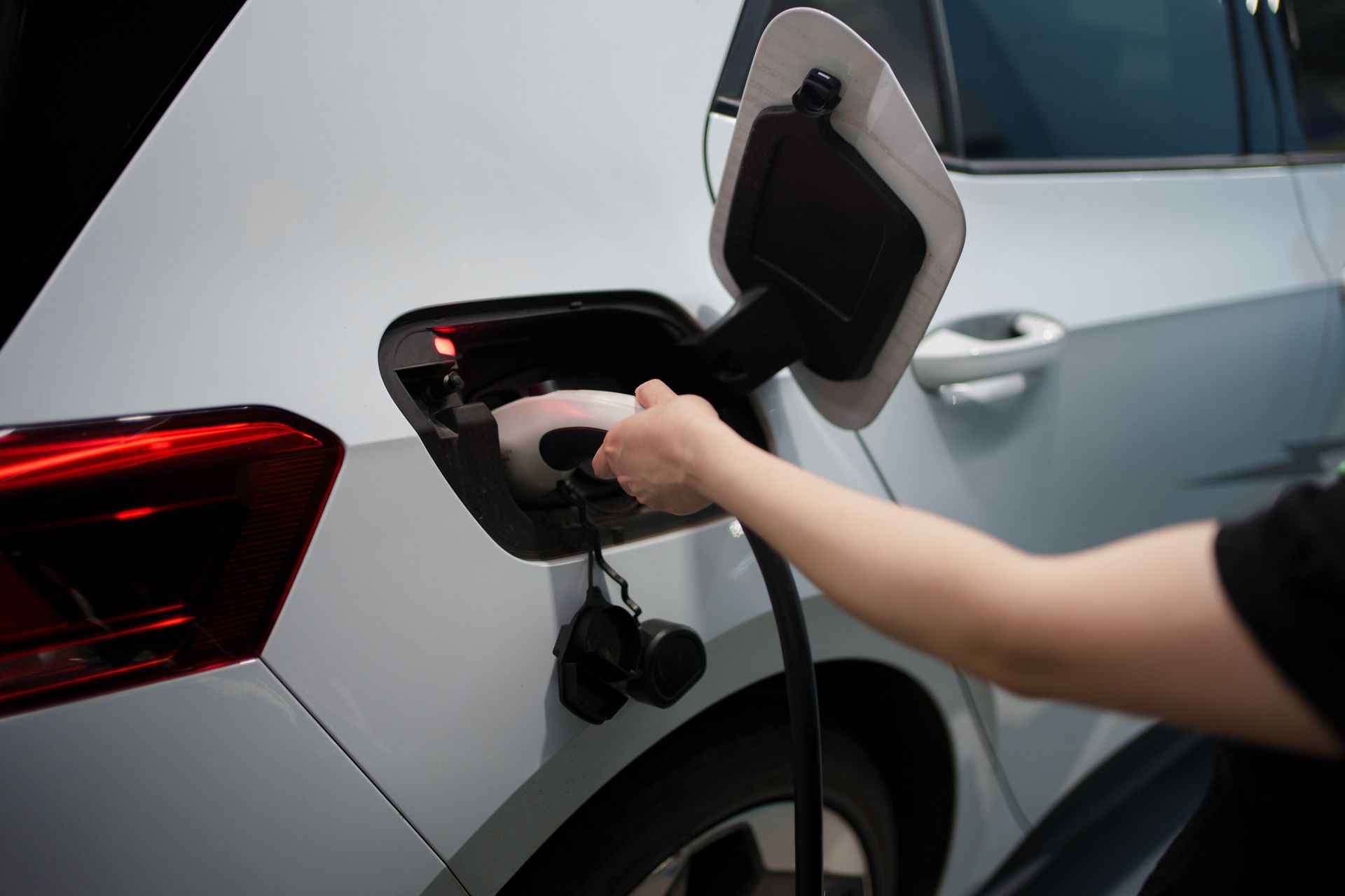 Resident plugging in a home EV charger in a Buffalo Grove garage.