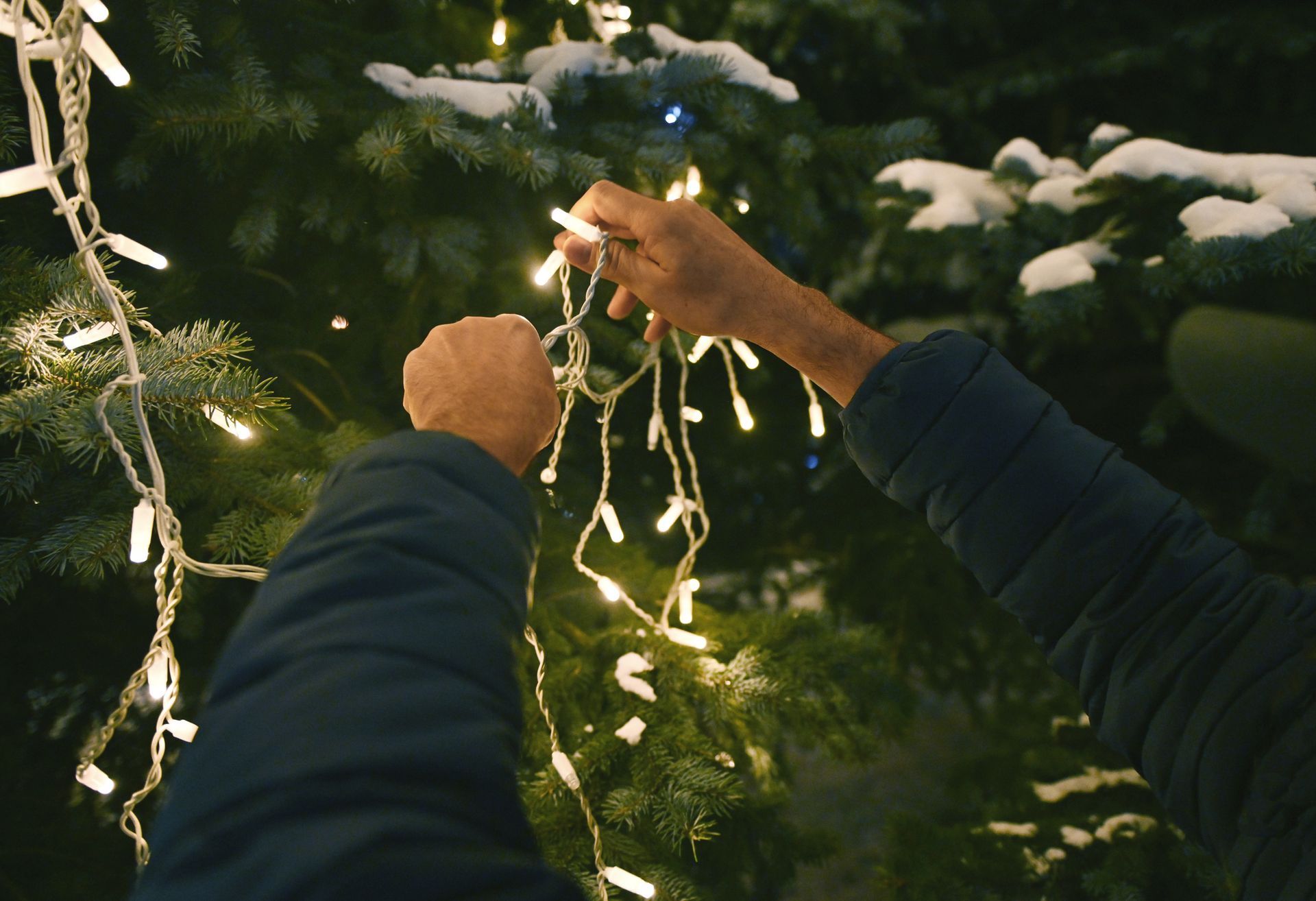 Family decorating their home with holiday lights safely in Buffalo Grove Illinois.